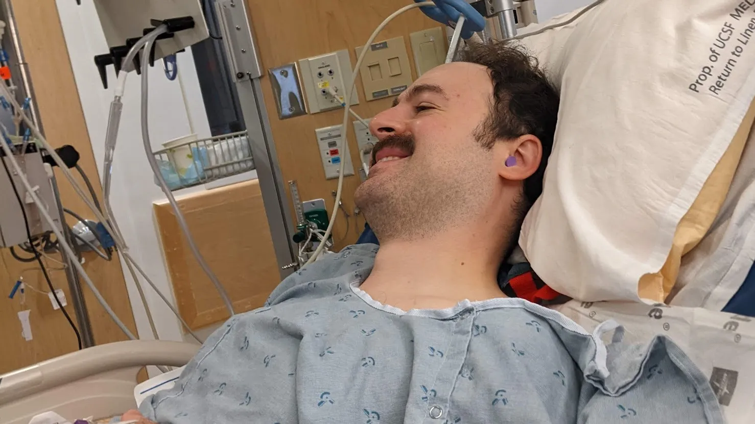 A photo of me in the ICU, smiling, after hearing silence for the first time in 8 months
